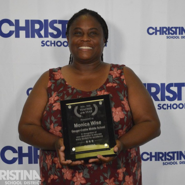 Photo of Monica Wise Teacher of the Year Gauger-Cobbs MS with award